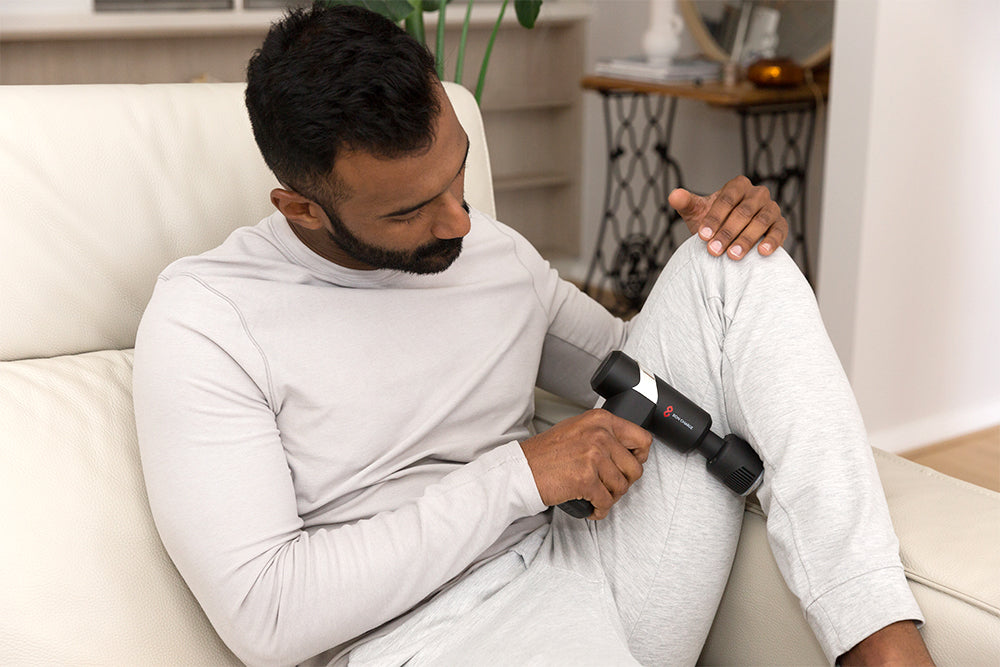 Man Using Cold & Heat Therapy Massage Gun