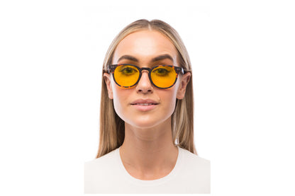 Woman Wearing Clarke Light Sensitivity Glasses Readers