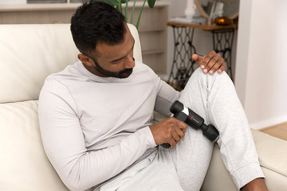Man Using Cold & Heat Therapy Massage Gun